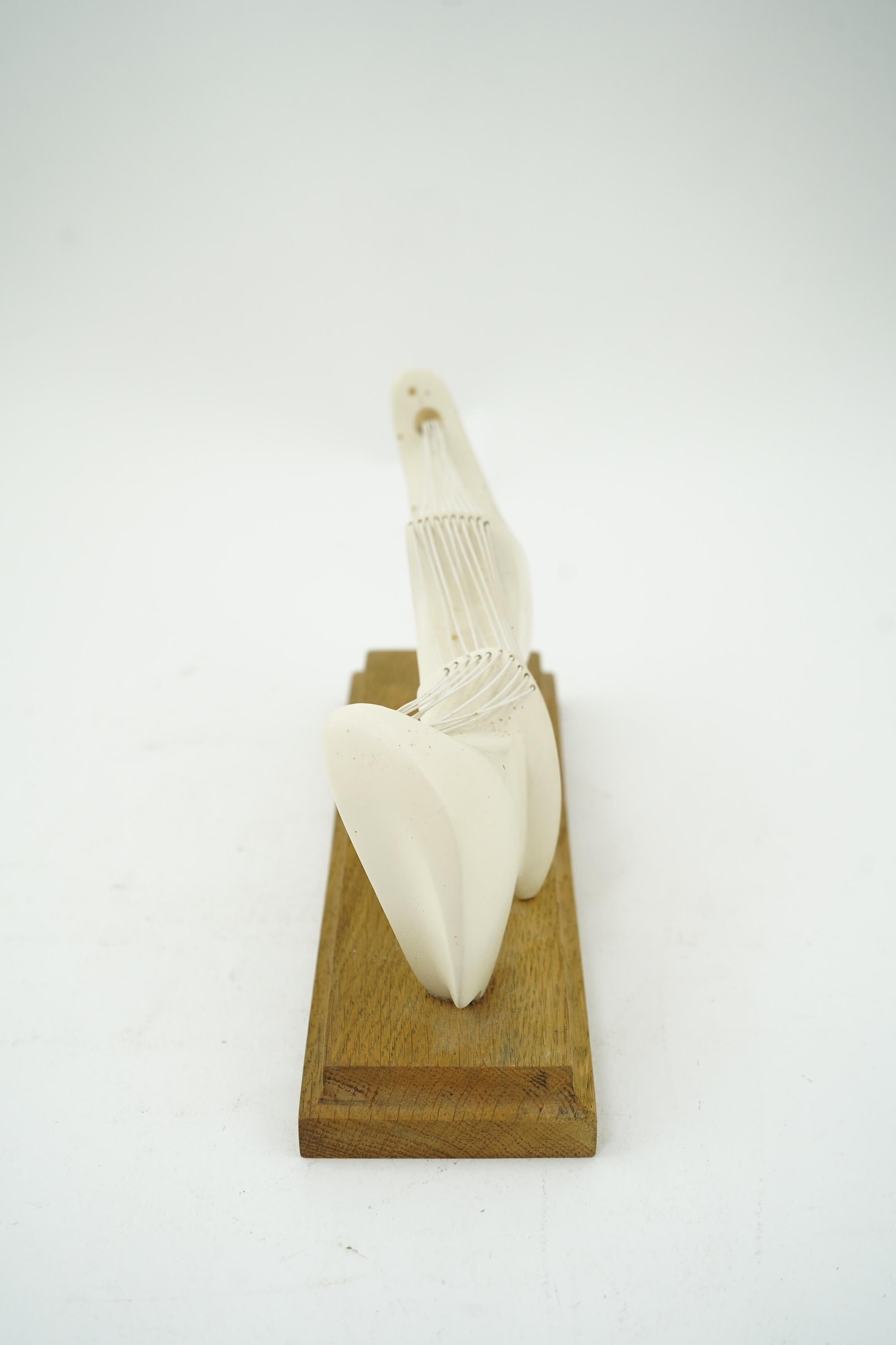 Follower of Henry Moore (1898-1986) A modernist stringed plaster sculpture raised on an oak rectangular plinth base, 25cm wide